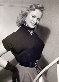 Sabrina in her six-button belt and black gloves
