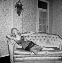 Sabrina recling on a couch 4 Feb 1957